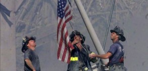 152775_firefighters-raise-a-us-flag-at-the-site-of-the-world-trade-center-after-two-hijacked-commercial-air